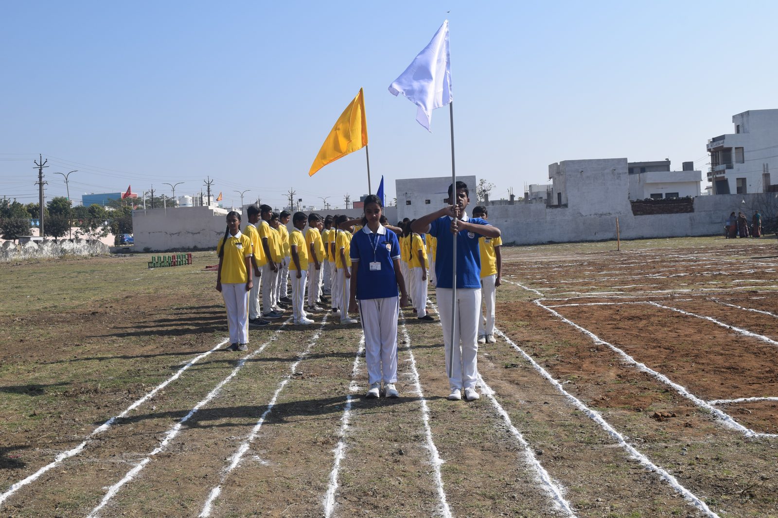 House captains leading the Sports Day march past with flags